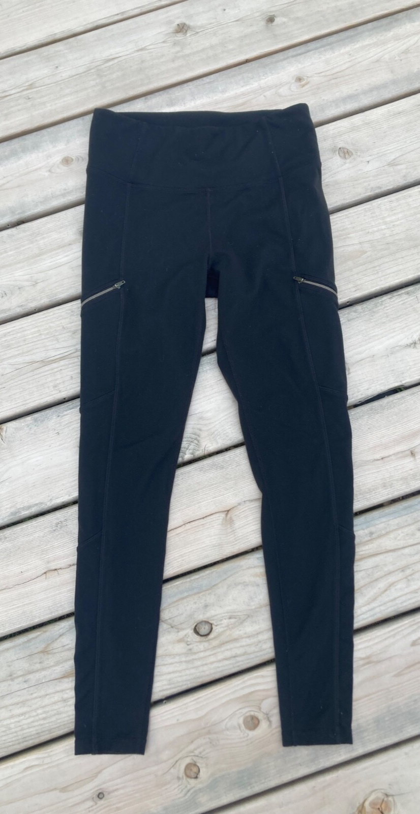 Athleta black leggings with angled zippers in size medium