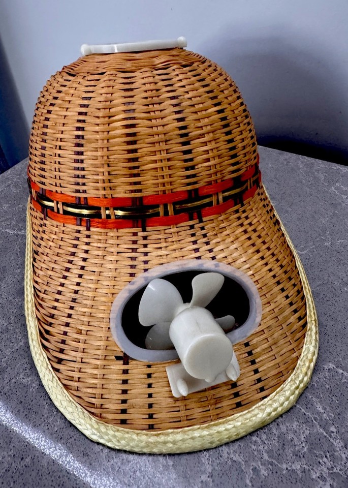 A genuine vintage solar-powered fan built into a straw hat — an utterly bonkers, one-of-a-kind retro gadget you can actually wear.