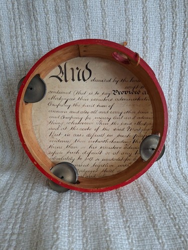 Vintage handmade tambourine with a drumhead made from a piece of old Parchment.