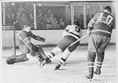 Detroit Red wing Gordie Howe blocked two ways as he tries a shot g- Old Photo