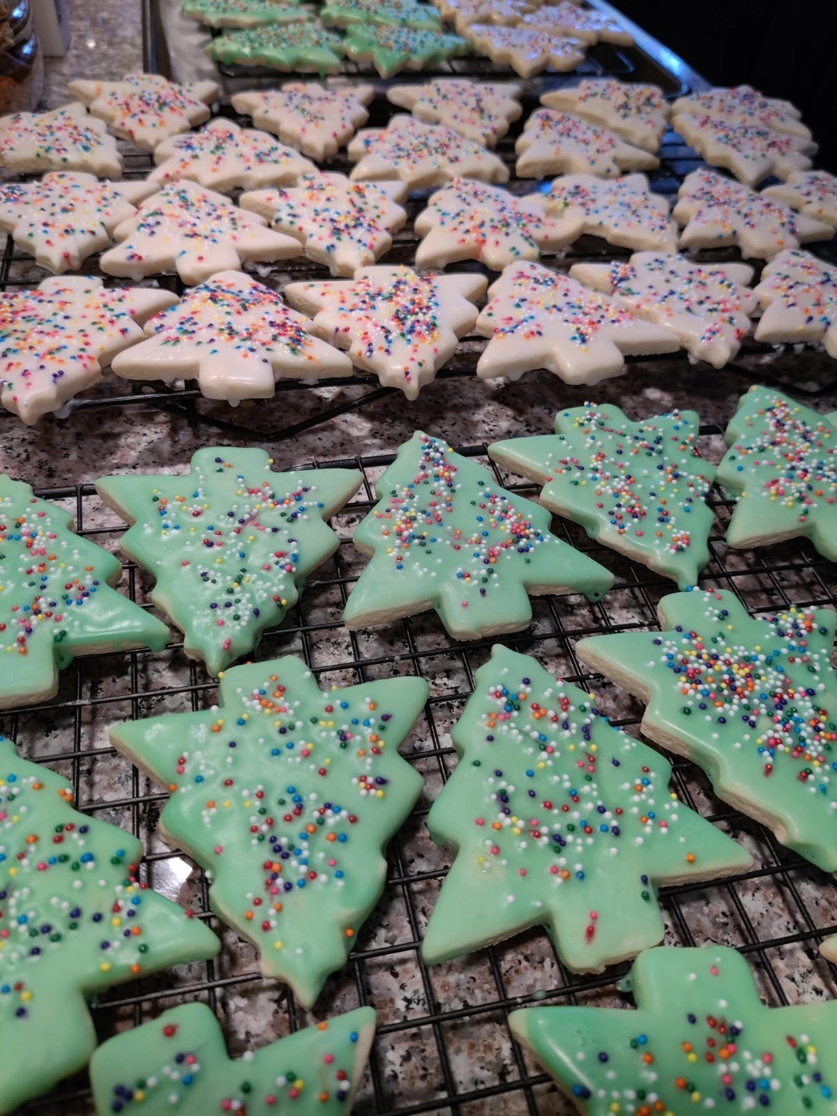 Green and white homemade Christmas Tree Sugar Cookies with colorful sprinkles