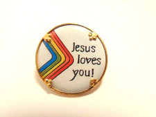 small, older religious pin, metal back with plastic front; Jesus Loves You 