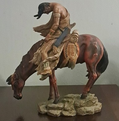 Native American  with horse standing in rock, referred to as ''End of the trail''