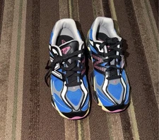 New Balance 9060 sneakers in the "Blue Oasis/Real Pink" colorway.