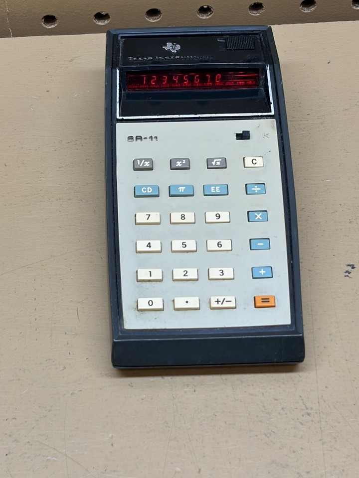 A working 1970s Texas Instruments SR-11 'Electronic Slide Rule' calculator — one of the earliest consumer scientific calculators ever made, and the name alone is a beautiful time capsule.