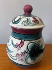 Gail Pittman lidded canister is decorated with a distinctive red grapevine patte