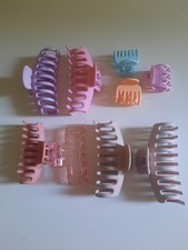 collection of pastel and neutral plastic hair claw clips in various shapes...