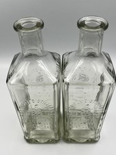 Two Vintage Bushmills Distillery Glass Bottles, 24 cm high.