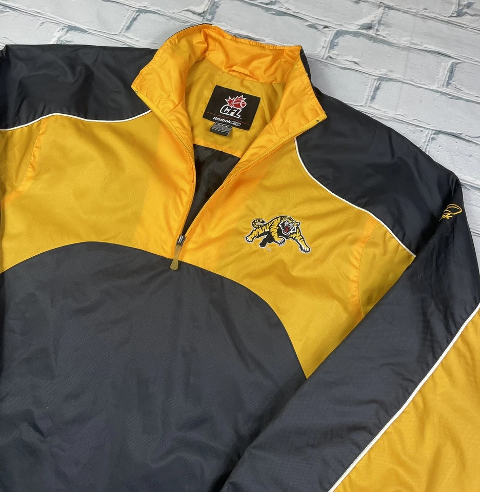 Chaqueta CFL Hamilton Tiger-Cats Reebok 1/4 Cremallera De Colección Negra y Dorada Para Hombre Talla M Foto 2 de 4
