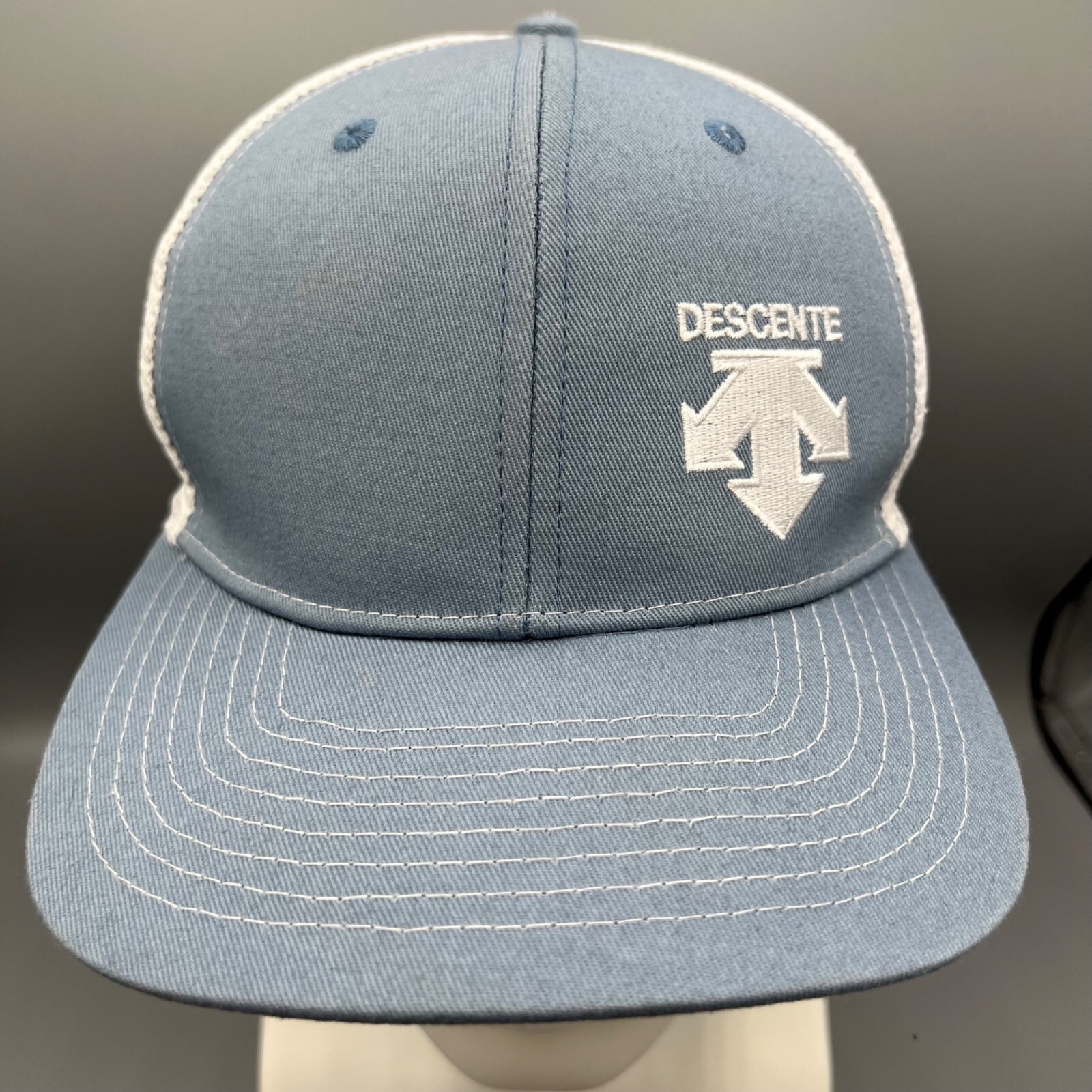 Descente Skiing Mesh Back Six Panel Blue and White Embroidered Logo Trucker Hat