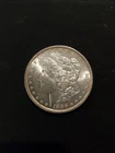 1886 AU MORGAN SILVER DOLLAR