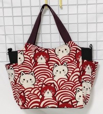 Handmade tote bag with cat pattern, wave design, and burgundy side pockets.