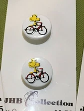 Collectable set Peanuts buttons woodstock snoopy bike plastic JHB Collection