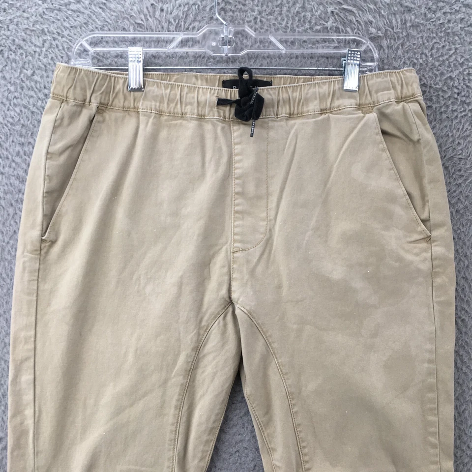 Pantalones de chándal Pacsun para hombre medianos beige cintura elástica ajuste ajustado cremallera tobillo Foto 2 de 4