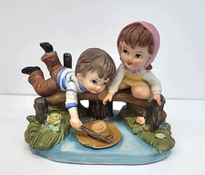 Artmark Porcelain Figurine of Boy & Girl on Bridge Retrieving Hat From Stream