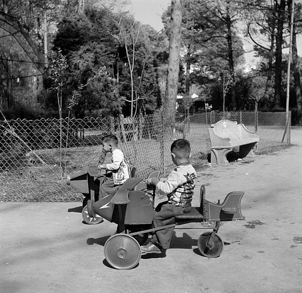 Mexico City Two small boys take a tricycle ride zoo Mexico C