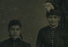 TWO YOUNG WOMEN, DARKLY DRESSED, MANY BUTTONS. TINTYPE.