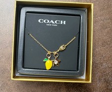 Coach Gold Plated necklace with a mango & Star Charms