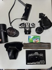 Olympus OM-10 35mm SLR Camera with 3 lenses and misc. Accessories