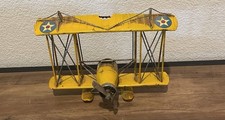 Ancienne rondelle à suspendre modèle biplan métal jaune décor étoile US