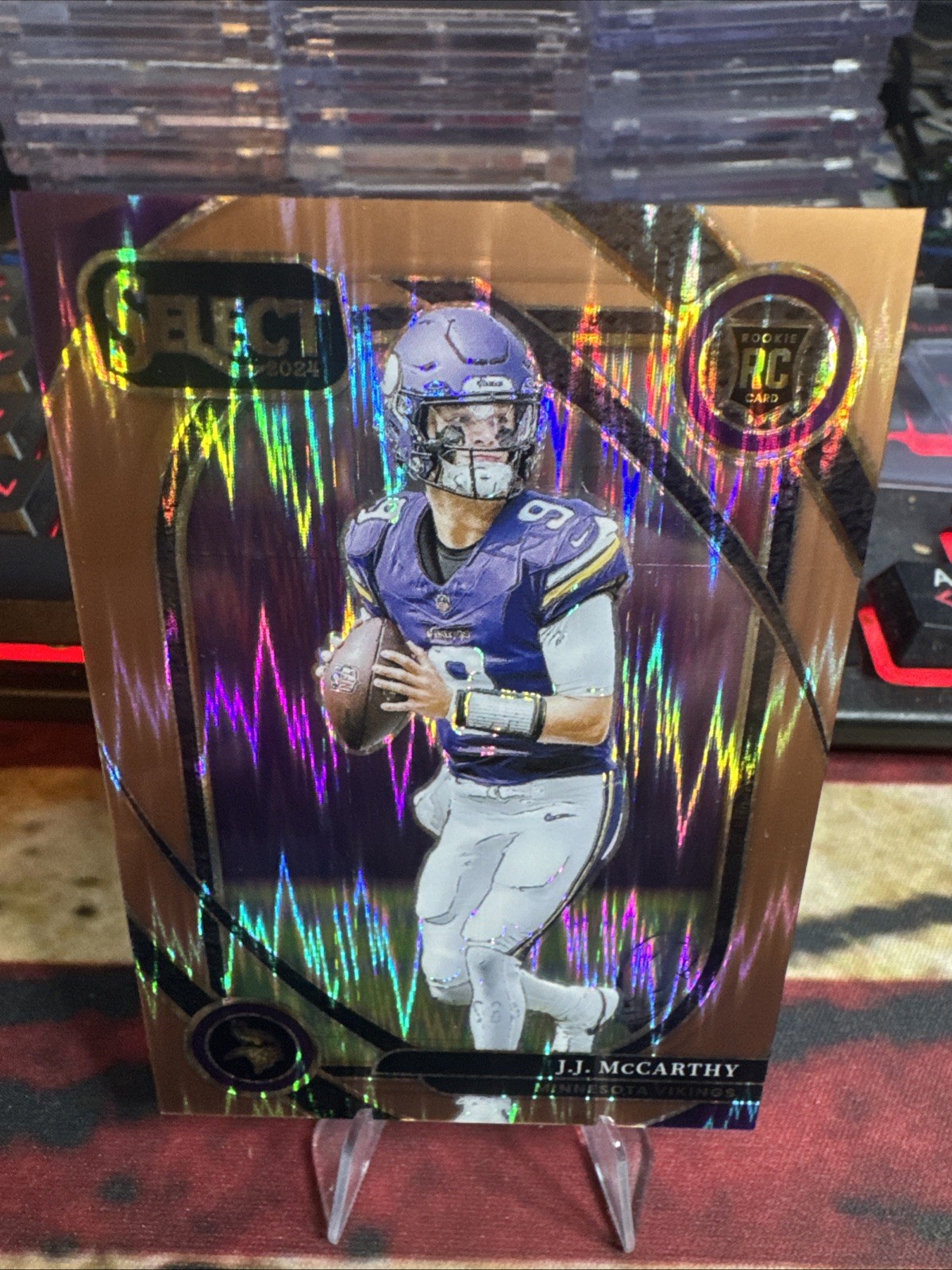 J.J. McCarthy 2024 Panini Select Copper Prizm Shock #246 SN,RC,/299