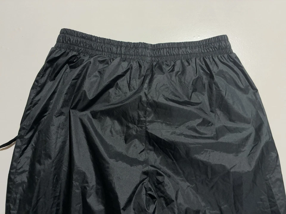 Pantalones deportivos Hummel negros para hombre medianos de nailon forrados con malla calentamiento cremallera al tobillo Foto 4 de 4