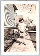 Vtg B&W Snapshot Adorable Girl In Dress By Porch 1930s