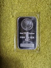 1 troy ounce Highland Mint silver bar featuring a Morgan Dollar design.BU