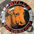 VINTAGE DR. BULL’S COUGH SYRUP 12 INCH CONVEX PORCELAIN ENAMEL SIGN