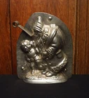 Antique Christmas two part chocolate mold  of Santa Claus pulling on ear of boy