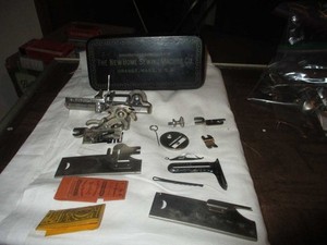 New Home Singer Sewing Machine Co. parts box with Various attachments Vintage 