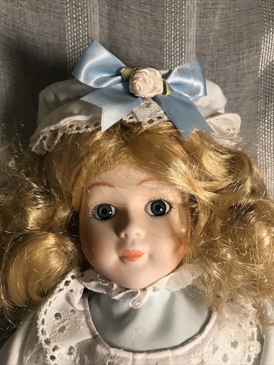 ALBERON COLLECTABLE Porcelain doll, blond blue bow collectable
