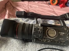 A Canon XH-A1 Camcorder With Computer Adapter, Batteries Charger, Tapes
