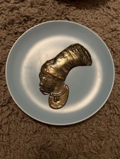 A vintage Poole Pottery wall plaque featuring an African bust with Mheaddress