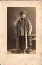 Real Photo Postcard Portrait of a Foreign Military Dressed Man in a Photo Studio