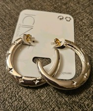 Silver-tone chunky hoop earrings with a star pattern