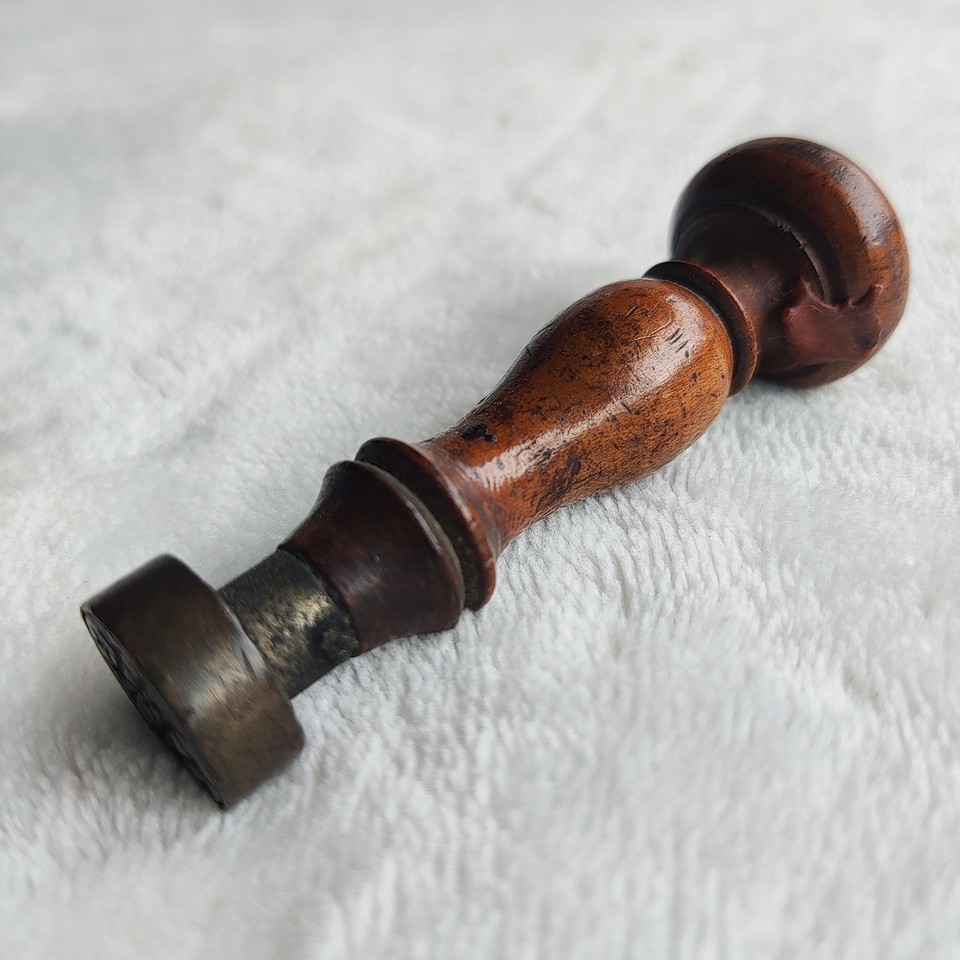 A substantial antique wood-and-bronze wax seal stamp — the kind of heirloom desk object that makes correspondence feel like an event.