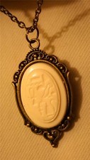 Delightful Victorian-Inspired Brasstone Creamy Egyptian Symbols Pendant Necklace