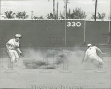 1961 Press Photo Edison's Thompson surrounded by dust, called out at 2nd base.