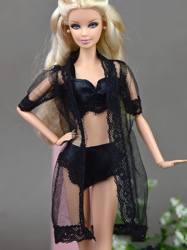 sexy barbie lingerie Royalty-Free photo: Woman wearing black lace bikini lying on satin bed  comforter main image 0