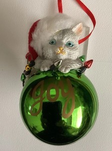 Cat Playing With Lights Green Plastic Ball Ornament with Joy Written on Front 4”