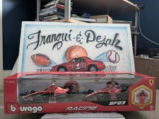 Burago 1:24 SF23 Formula Racing Ferrari SF23 w/Charles Leclerc & Carlos Sainz 