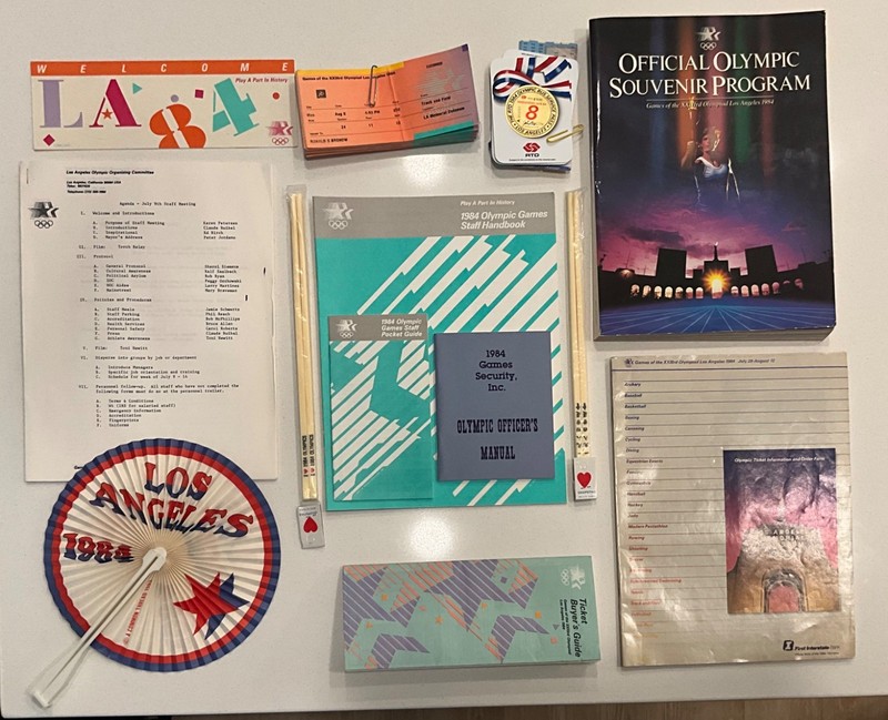 assortment of 1984 olympic memorabilia and guides