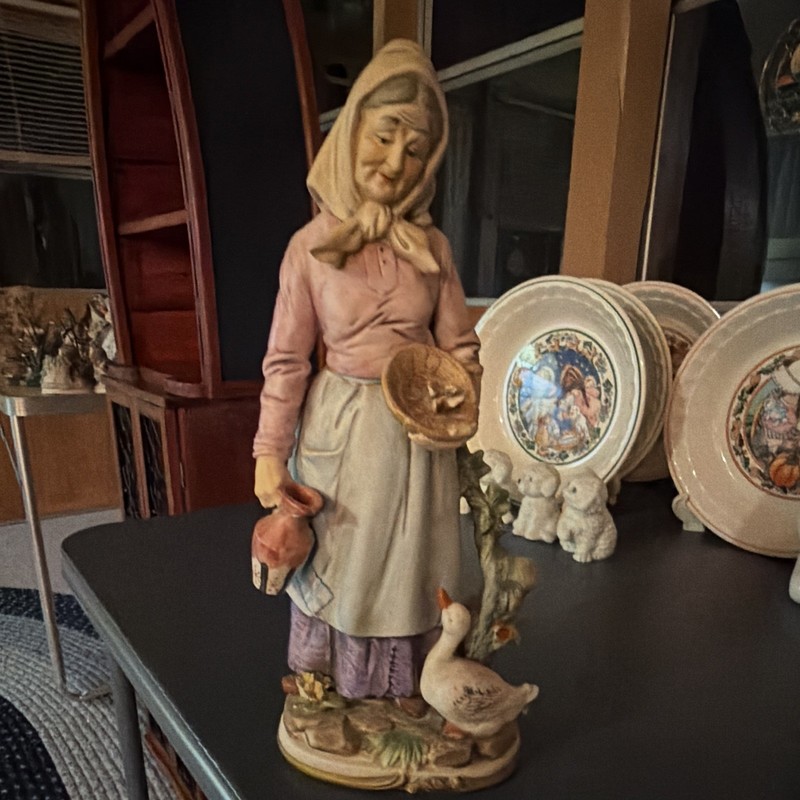 Vintage Homco porcelain figurine featuring an elderly woman feeding a goose