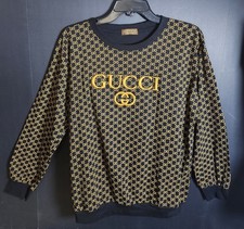 Gucci GG cotton-blend jacquard sweater featuring a dark blue and gold design.