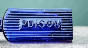 Very small triangular shape cobalt blue glass poison bottle