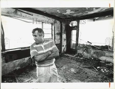 Press Photo Owner Sidney Kramer inspects fire damage at Seagull Hotel