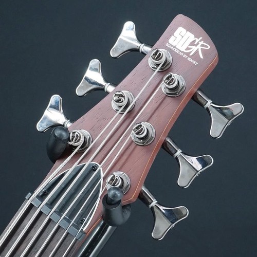 Ibanez SR506-BM bass guitar with silver hardware, six tuning pegs, and visible “SDGR” logo on head.