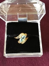  marquise blue topaz  set in a 14k gold ring with 6 diamonds