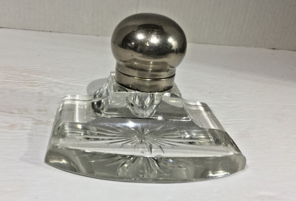 A proper Victorian-era glass inkwell with a silver-plate domed lid — the kind of desk piece that makes visitors stop and ask about it.